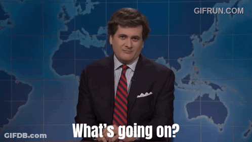 A Man In A Suit And Tie Says What 'S Going On In Front Of A Map GIF