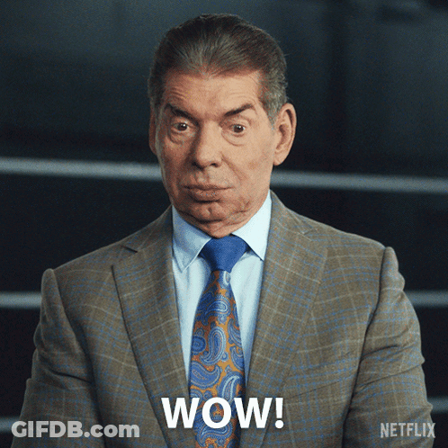 A Man In A Suit And Tie Says Wow On The Screen GIF
