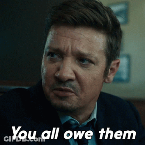 A Man In A Suit And Tie Says " You All Owe Them " In White Letters GIF