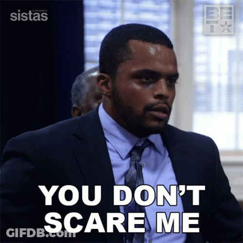 A Man In A Suit And Tie Says You Don T Scare Me GIF