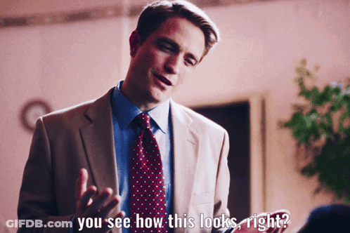A Man In A Suit And Tie Says " You See How This Looks Right ? " GIF