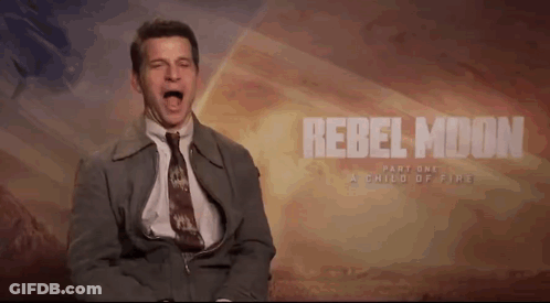 A Man In A Suit And Tie Screams In Front Of A Rebel Moon Part One Poster GIF