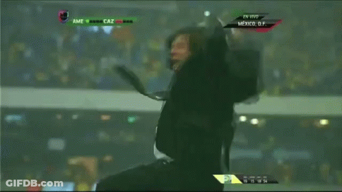 A Man In A Suit And Tie Screams While Watching A Soccer Game GIF