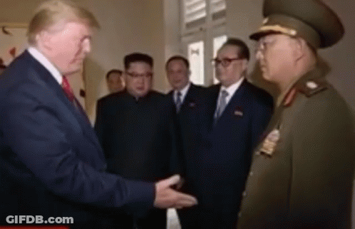 Man In Suit Shaking Hands With Military Man GIF