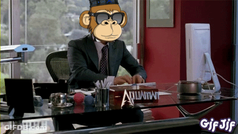 A Man In A Suit And Tie Sits At A Desk With A Sign That Says Atlantis GIF