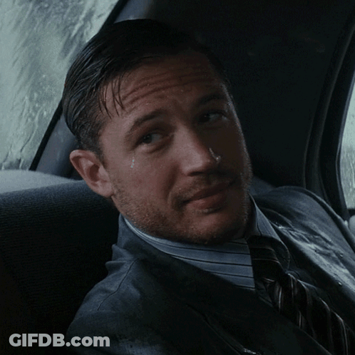 A Man In A Suit And Tie Sits In A Car GIF