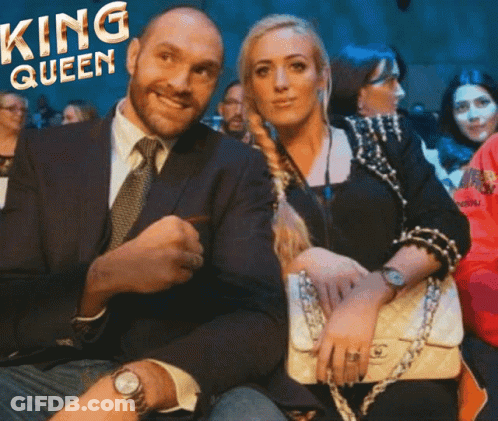 A Man In A Suit And Tie Sits Next To A Woman With The Words King Queen On The Bottom GIF