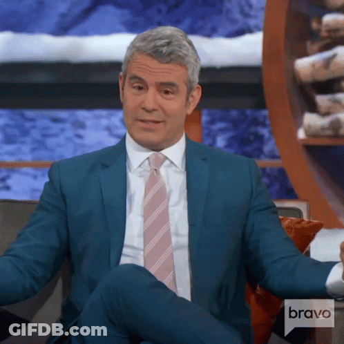 Man In Suit Sitting On Couch With Bravo Logo GIF