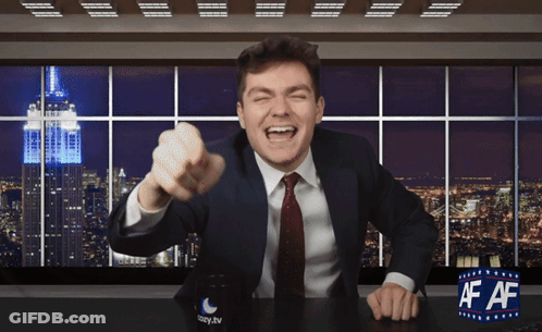 A Man In A Suit And Tie Sitting At A Desk With A Cup That Says Easy.tv On It GIF