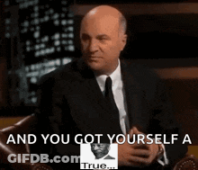A Man In A Suit And Tie Sitting In A Chair With The Words " And You Got Yourself A True " On The Bottom GIF