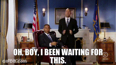 A Man In A Suit And Tie Sitting In A Chair With The Words Oh Boy I Been Waiting For This Above Him GIF