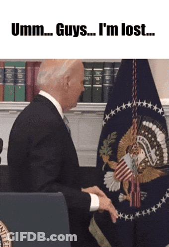 A Man In A Suit And Tie Sitting In Front Of A Flag With The Words Umm Guys I 'M Lost GIF