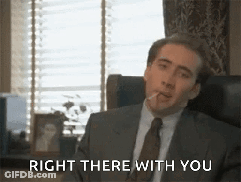 A Man In A Suit And Tie Smoking A Cigarette And Saying Right There With You . GIF