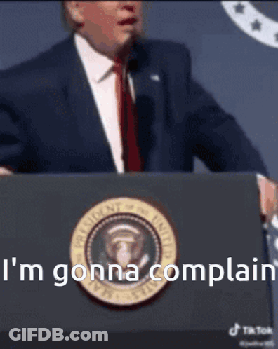 A Man In A Suit And Tie Stands At A Podium And Says I 'M Gonna Complain .. GIF