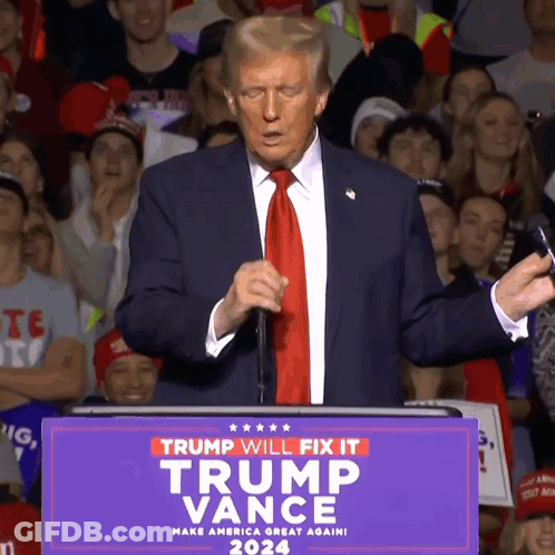 A Man In A Suit And Tie Stands At A Podium That Says Trump Will Fix It Trump Vance 2024 GIF