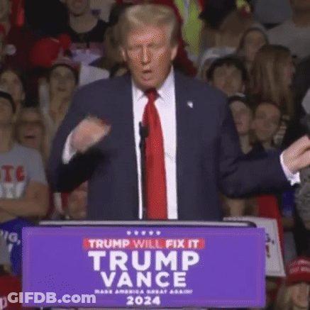 A Man In A Suit And Tie Stands At A Podium With A Sign That Says Trump Will Fix It GIF