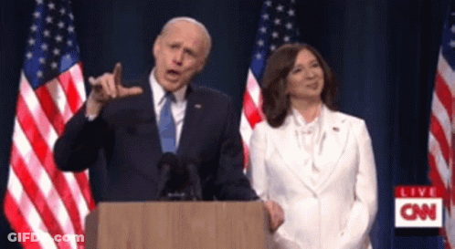 Man At Podium With Woman In White GIF