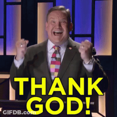 A Man In A Suit And Tie Stands At A Podium With His Fist In The Air And Says Thank God GIF
