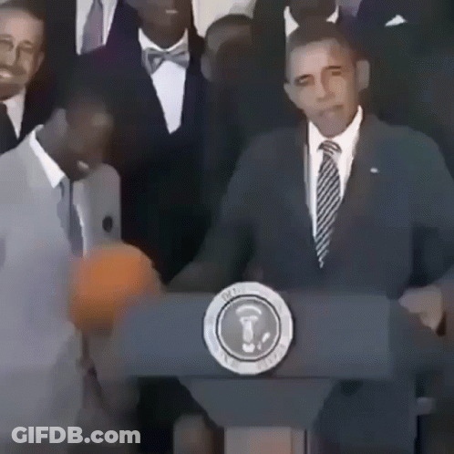 A Man In A Suit And Tie Stands Behind A Podium With The Seal Of The President Of The United States GIF