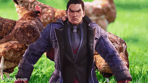 A Man In A Suit And Tie Stands In A Field With Chickens GIF