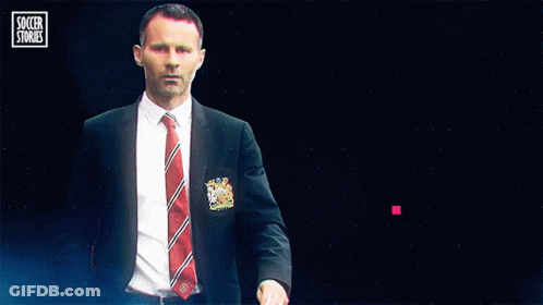 A Man In A Suit And Tie Stands In Front Of A Blue Background That Says Soccer Stories GIF