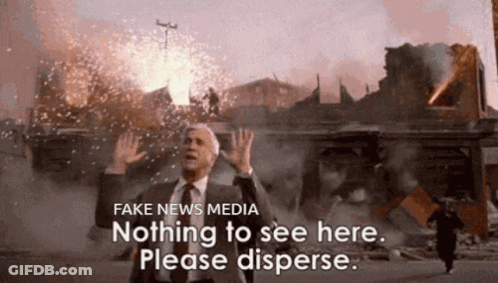 A Man In A Suit And Tie Stands In Front Of A Building That Is On Fire And Says Fake News Media Nothing To See Here GIF