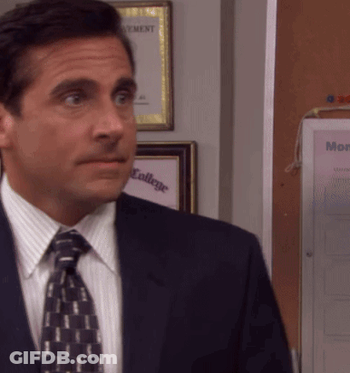 A Man In A Suit And Tie Stands In Front Of A Bulletin Board That Says " Monday " GIF