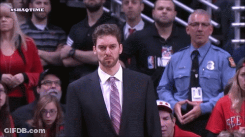 A Man In A Suit And Tie Stands In Front Of A Crowd With The Hashtag Shaqtime On The Bottom GIF