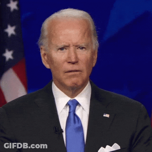 Man In Suit And Tie In Front Of Flag GIF