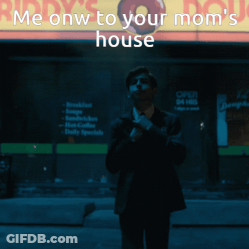 A Man In A Suit And Tie Stands In Front Of A Mcdonald 'S Sign GIF
