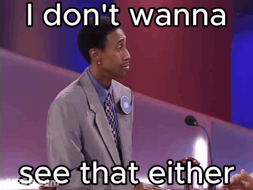 A Man In A Suit And Tie Stands In Front Of A Microphone With The Words I Don T Wanna See That Either Below Him GIF