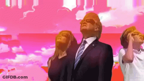A Man In A Suit And Tie Stands In Front Of A Pink Background GIF