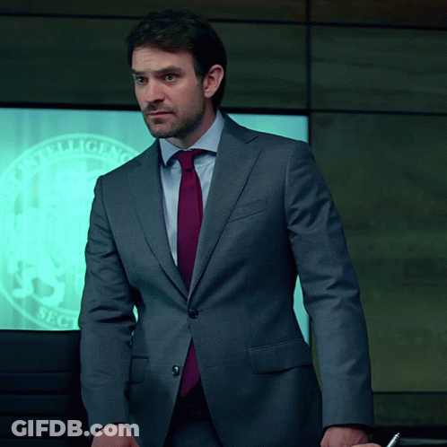 Man In Suit Standing In Front Of Intelligence Sec Screen GIF