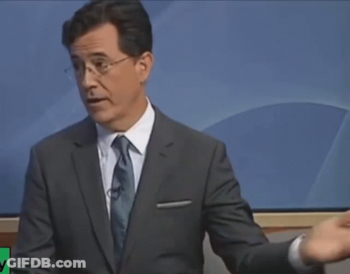 A Man In A Suit And Tie Stands In Front Of A Screen That Says ' Nbc News ' On It GIF