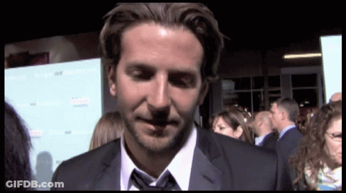 A Man In A Suit And Tie Stands In Front Of A Sign That Says ' A Few Good Men ' On It GIF