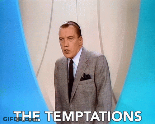 A Man In A Suit And Tie Stands In Front Of A Sign That Says " The Temptations " GIF