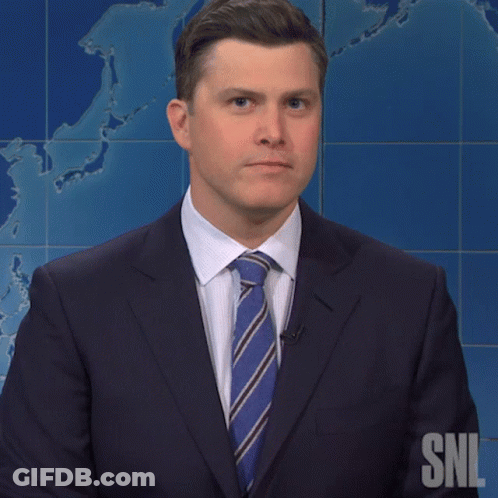 A Man In A Suit And Tie Stands In Front Of A Snl Map GIF
