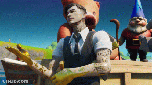 A Man In A Suit And Tie Stands In Front Of A Teddy Bear And A Gnome GIF