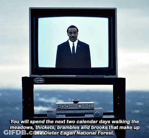 A Man In A Suit And Tie Stands In Front Of A Television Which Says You Will Spend The Next Two Calendar Days GIF