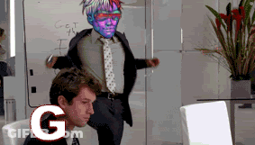 A Man In A Suit And Tie Stands In Front Of A White Board That Says Get The I On It GIF