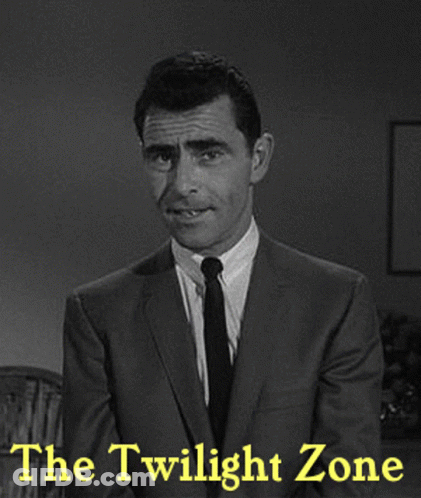 A Man In A Suit And Tie Stands In Front Of The Twilight Zone GIF