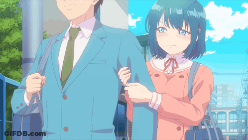 A Man In A Suit And Tie Stands Next To A Girl In A Pink Coat GIF
