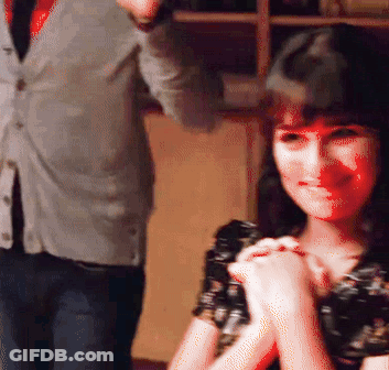 A Man In A Suit And Tie Stands Next To A Woman In A Black Dress GIF