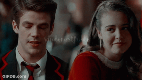 A Man In A Suit And Tie Stands Next To A Woman In A Red Dress With Randomestflasher Written On The Bottom GIF