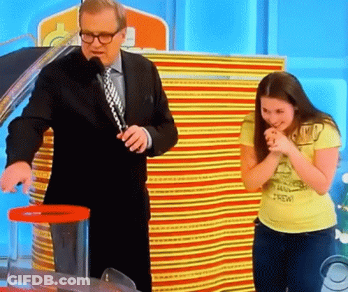 A Man In A Suit And Tie Stands Next To A Woman In A Yellow Shirt That Says Brew GIF