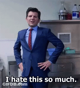 A Man In A Suit And Tie Stands With His Hands On His Hips And Says " I Hate This So Much " GIF