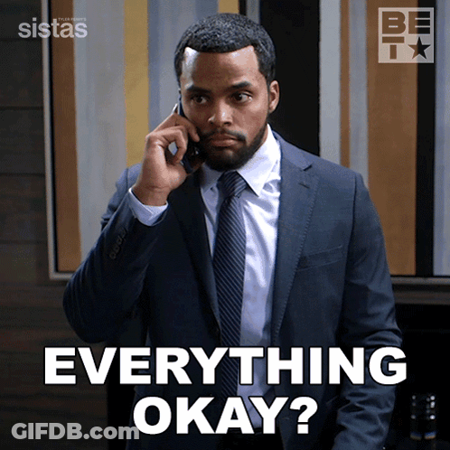 A Man In A Suit And Tie Talking On A Cell Phone With The Words Everything Okay Behind Him GIF
