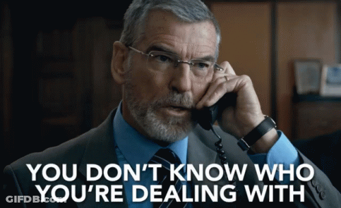A Man In A Suit And Tie Talking On A Phone With The Words " You Don 'T Know Who You 'Re Dealing With " GIF