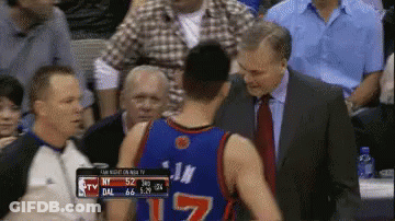 A Man In A Suit And Tie Talks To A Basketball Player Wearing Number 17 GIF