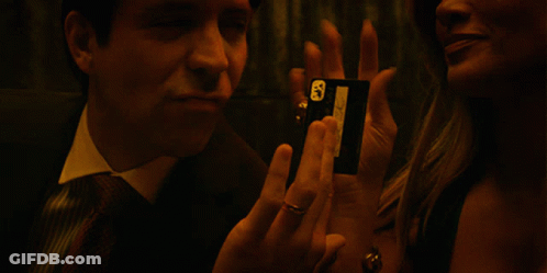 A Man In A Suit And Tie Talks To A Woman GIF